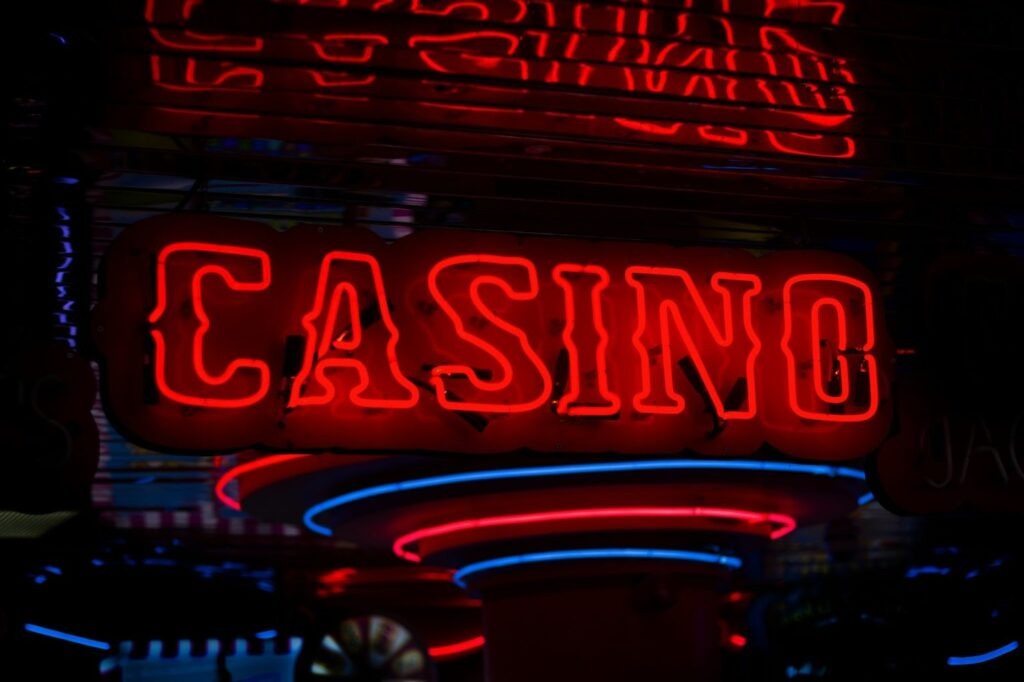A neon red casino sign with blue lights